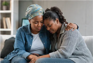 Two women comforting